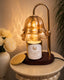 Decorative lamp with a floral design on a table next to a vase of flowers.