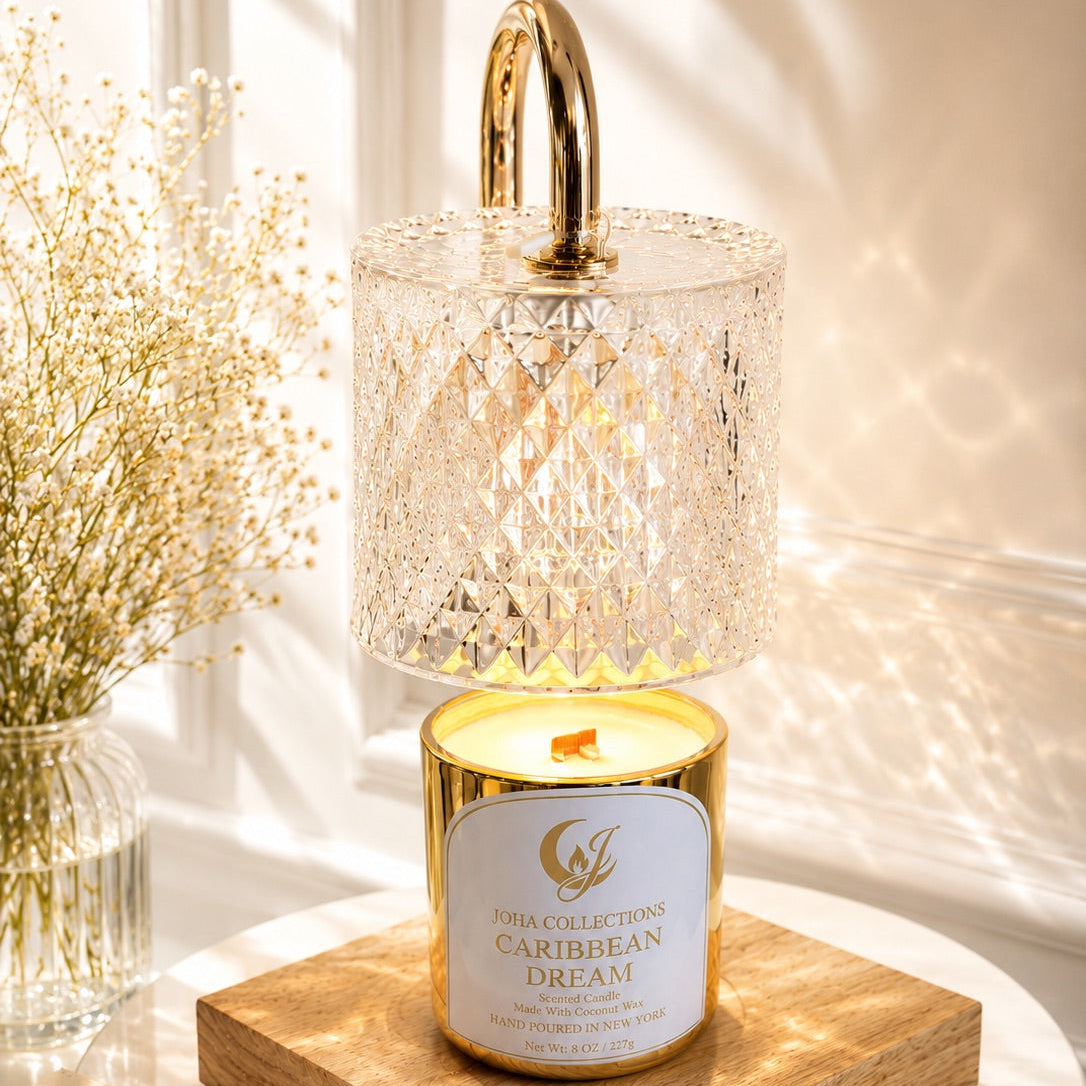 Decorative candle with gold holder on a wooden coaster, surrounded by soft lighting and plants.