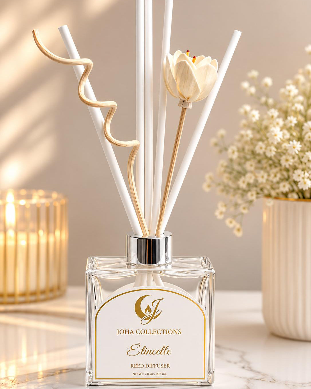 Reed diffuser with tulip sticks on a marble surface with decorative elements.