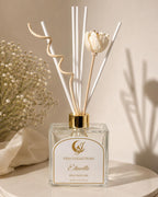 Reed diffuser with decorative elements on a neutral background