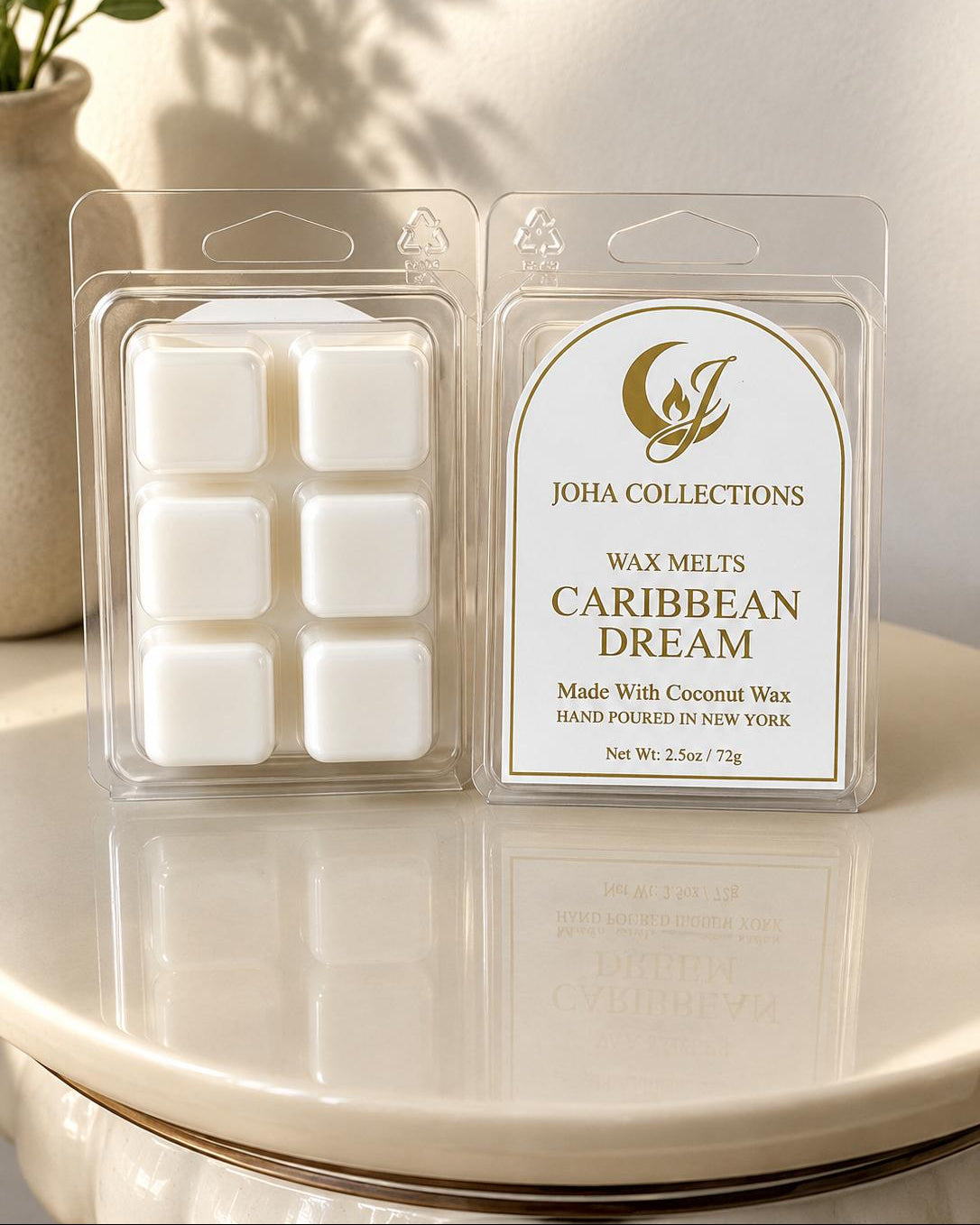 JOHA COLLECTIONS Caribbean Dream wax melts packaging on a white surface with a plant in the background.