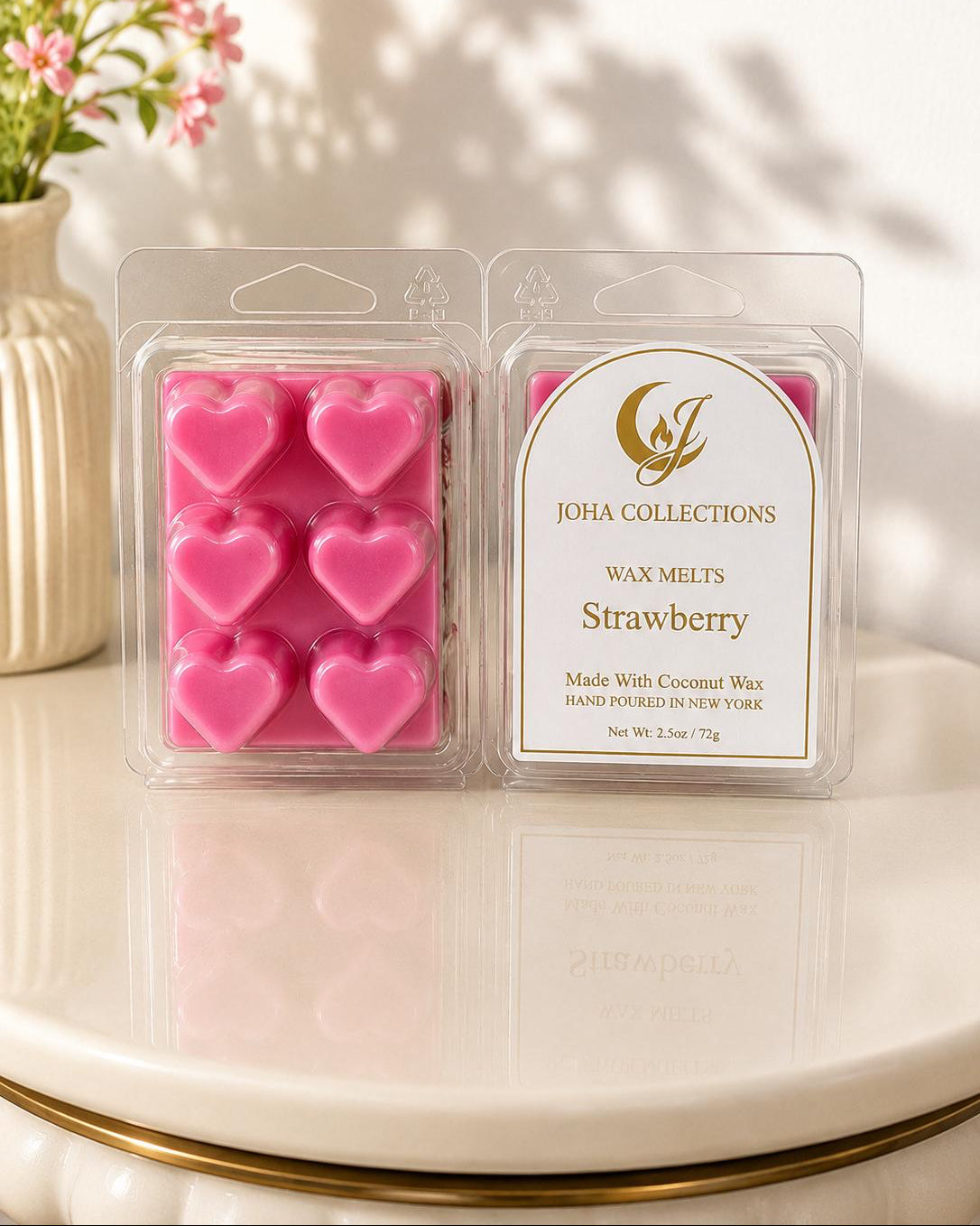 Pack of strawberry-scented wax melts with JOHA Collections branding on a decorative surface. Main image